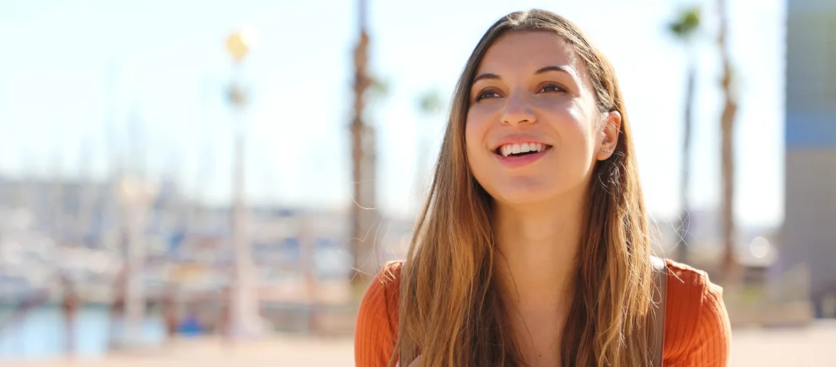A woman smiling outdoors
