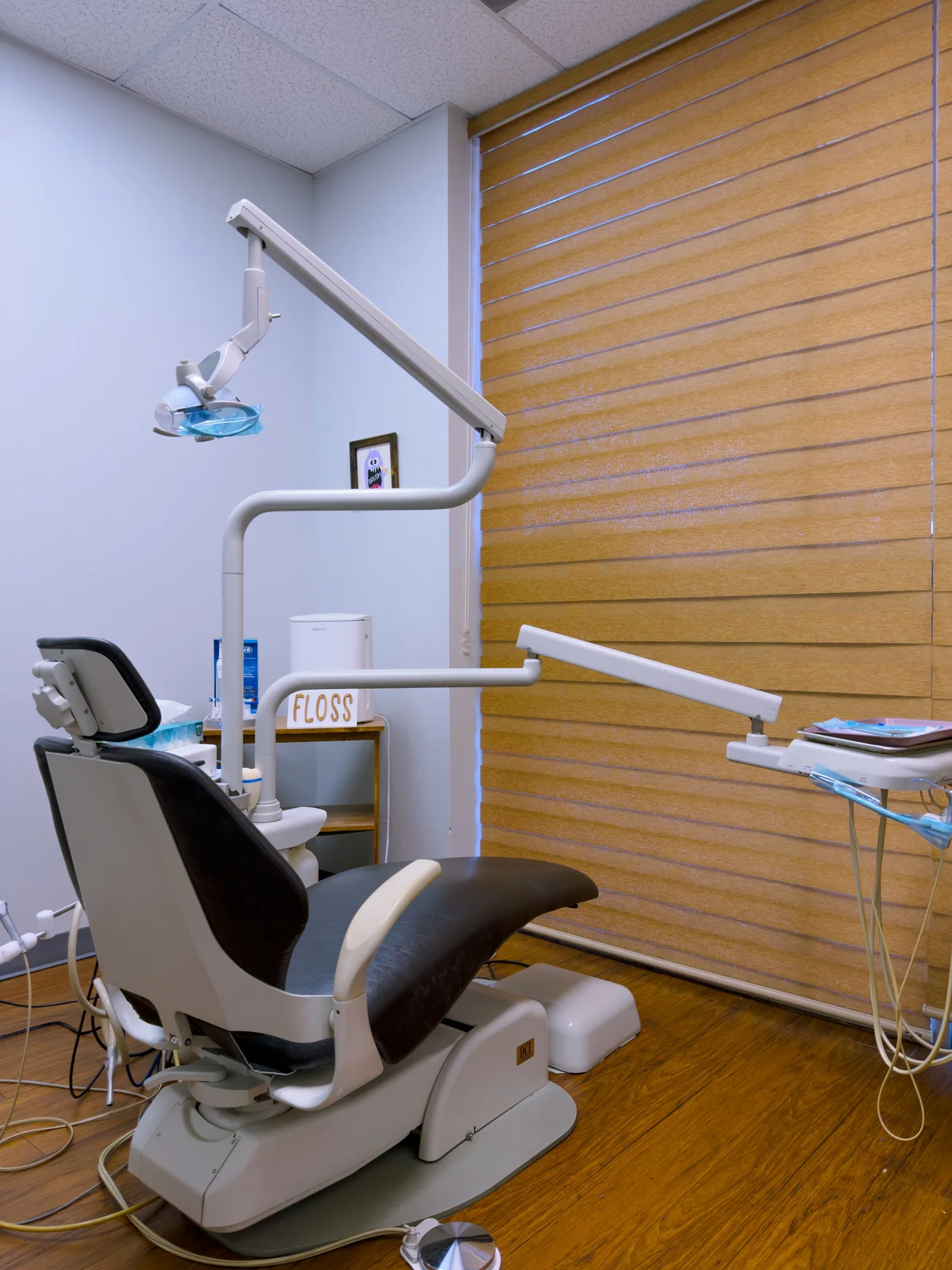 Dental chair beside wood window blinds